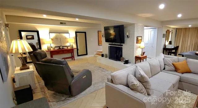 a living room with furniture a lamp and a window