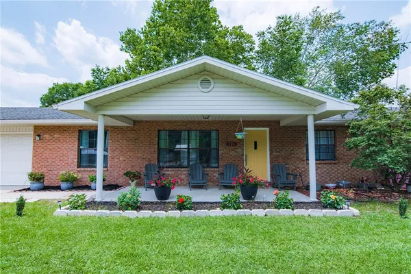 a front view of house with a garden