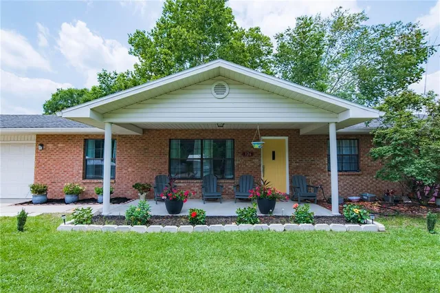 a view of a patio with chairs and potted plants