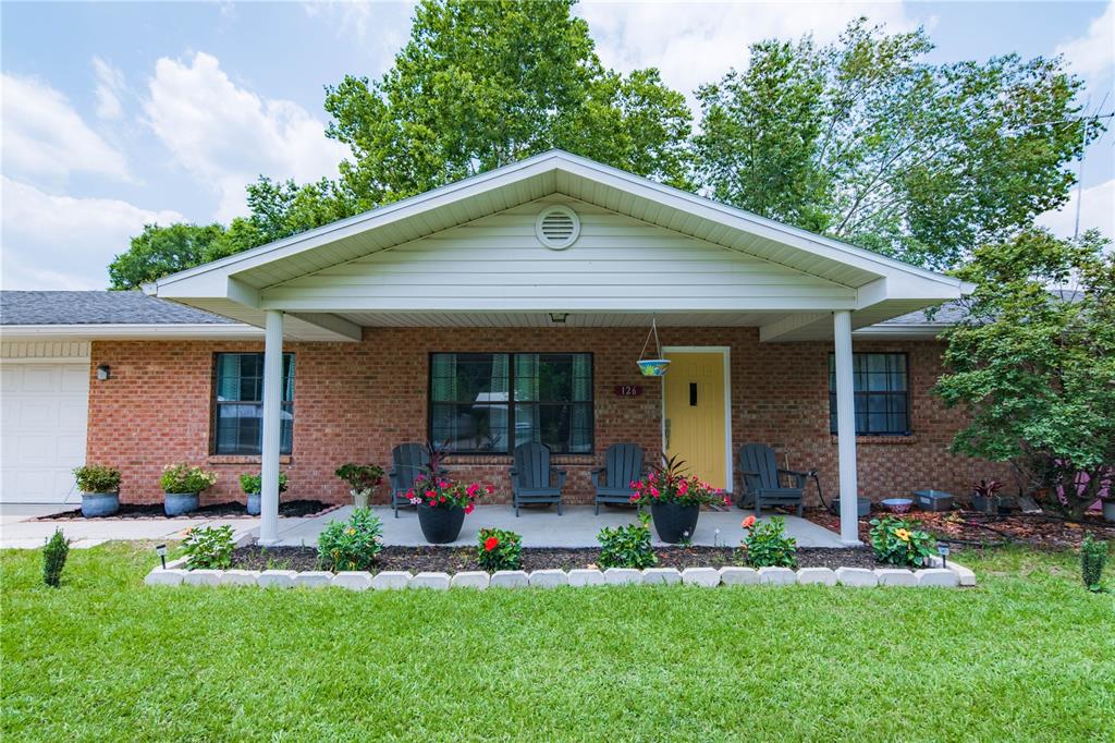 a front view of house with a garden