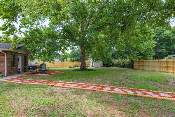a view of backyard with green space and porch
