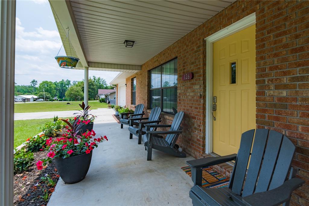 126 Southwest Mockingbird Way Lake City, FL 32024 - Photo 2 of 37 a view of a patio with chairs and potted plants