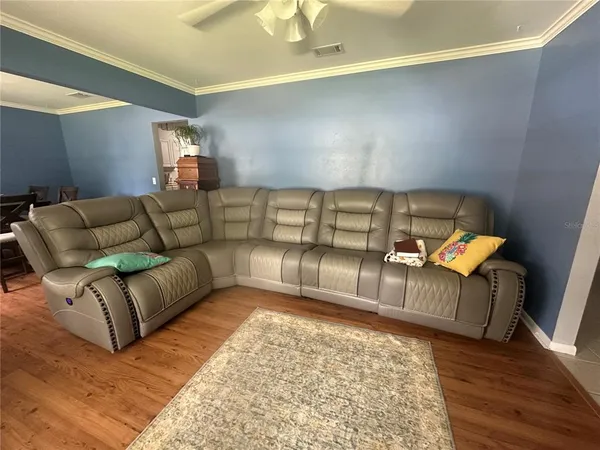 a living room with furniture and a chandelier
