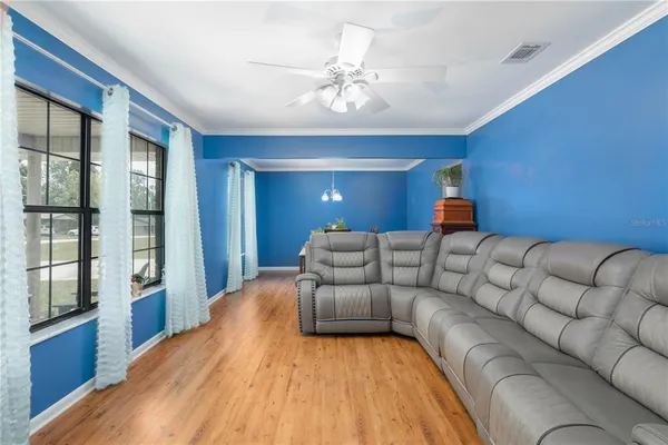 a living room with furniture and a kitchen