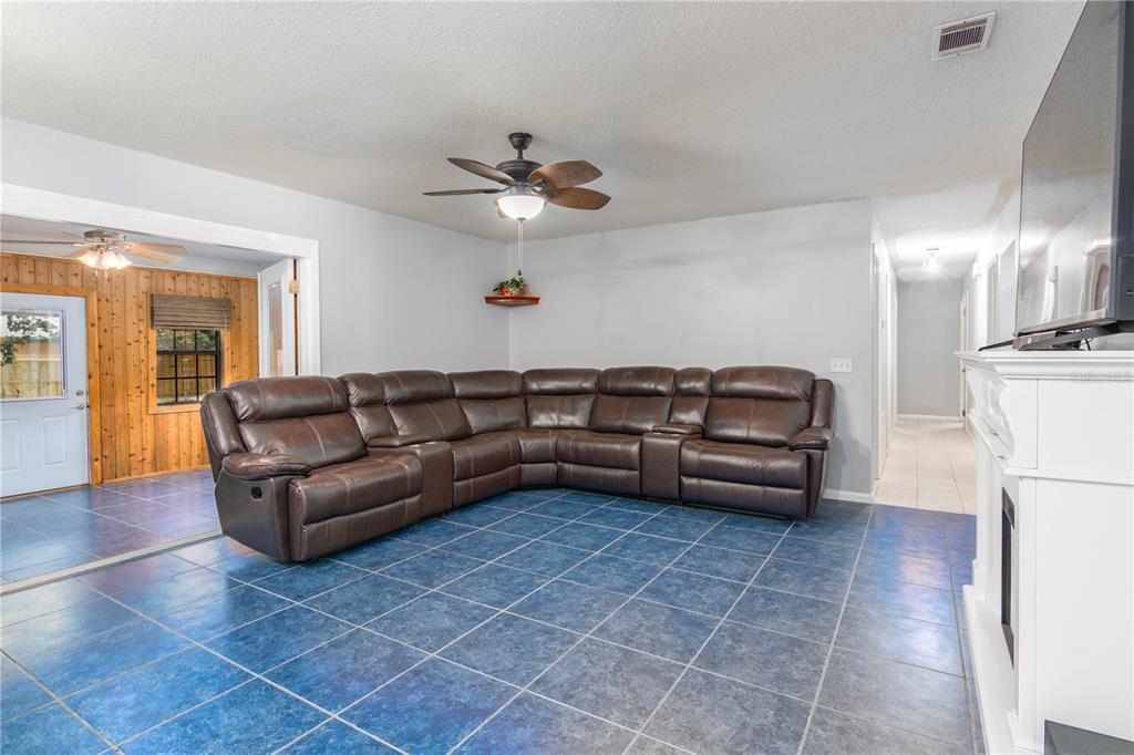 126 Southwest Mockingbird Way Lake City, FL 32024 - Photo 26 of 37 a living room with furniture and a chandelier