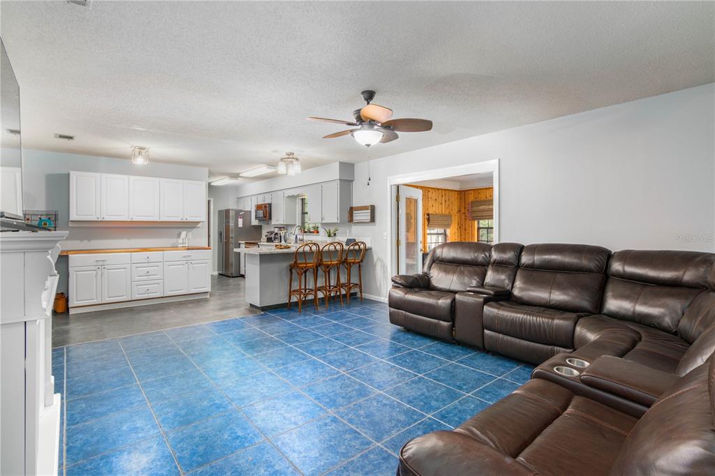 126 Southwest Mockingbird Way Lake City, FL 32024 - Photo 27 of 37 a living room with furniture and a kitchen