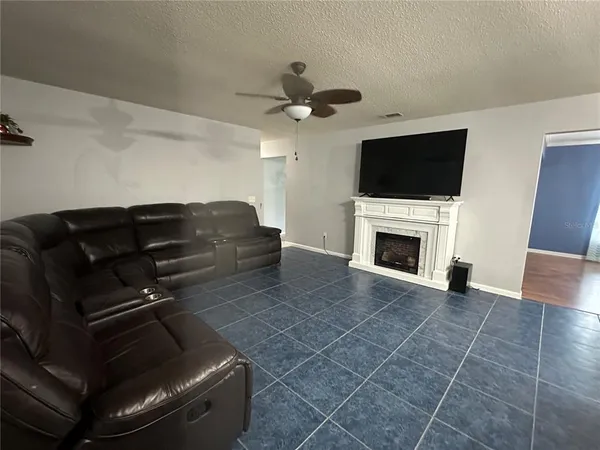 a view of an entryway with wooden floor and a livingroom