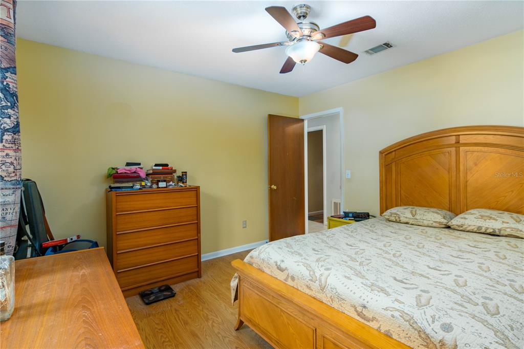 126 Southwest Mockingbird Way Lake City, FL 32024 - Photo 32 of 37 a bedroom with a bed and a chandelier