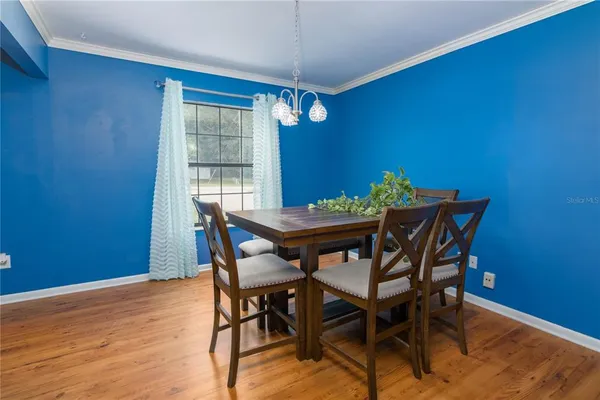 a view of a dining room with furniture and window