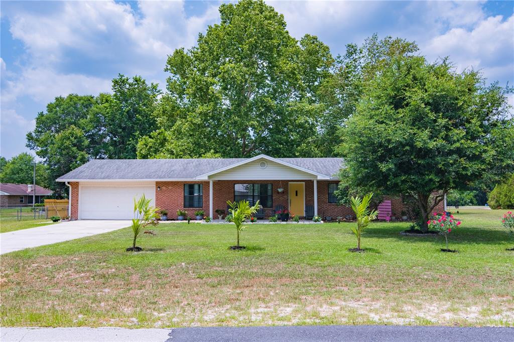 126 Southwest Mockingbird Way Lake City, FL 32024 - Photo 5 of 37 a front view of a house with garden