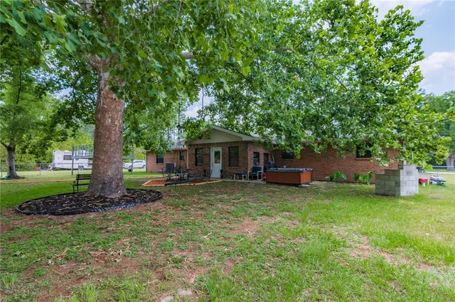 a view of a house with pool and a yard
