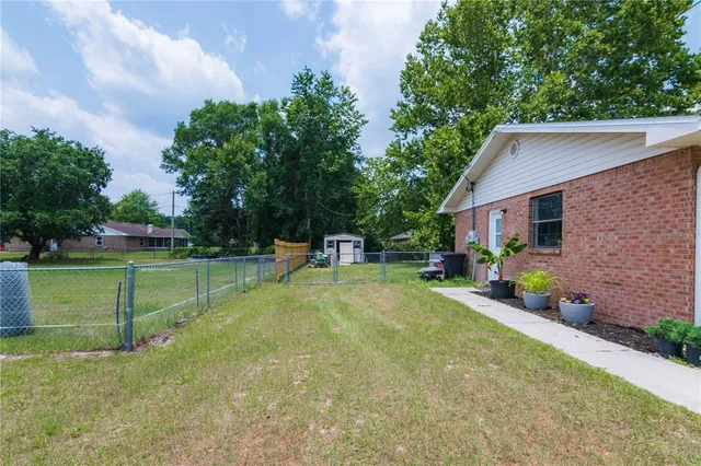 a view of a house with backyard sitting area and garden