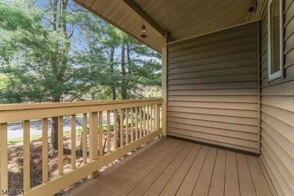 a view of a balcony with wooden floor