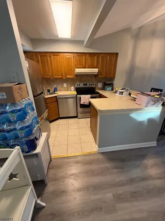 a view of kitchen with furniture and wooden floor