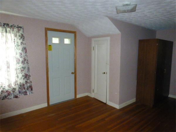30 Mason Road Dudley, MA 01571 - Photo 3 of 18 a view of empty room with window and wooden floor