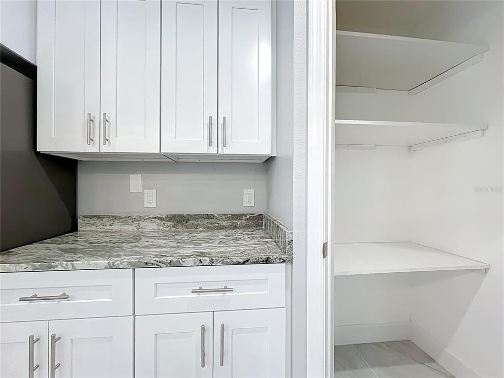 11963 Bentry Street Orlando, FL 32824 - Photo 18 of 80 a view of kitchen with granite countertop white cabinets and a sink