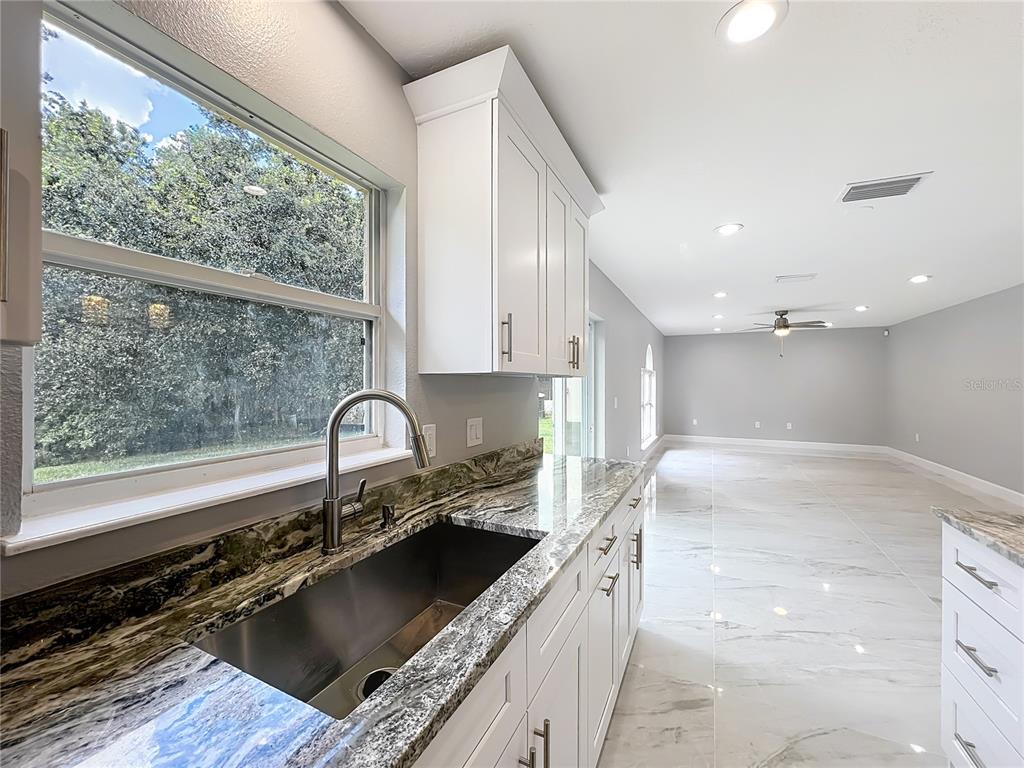11963 Bentry Street Orlando, FL 32824 - Photo 21 of 80 a kitchen with a sink and a stove top oven