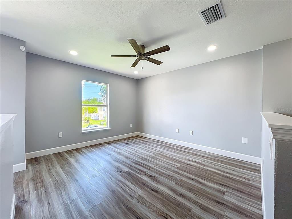 11963 Bentry Street Orlando, FL 32824 - Photo 34 of 80 an empty room with a window and a ceiling fan