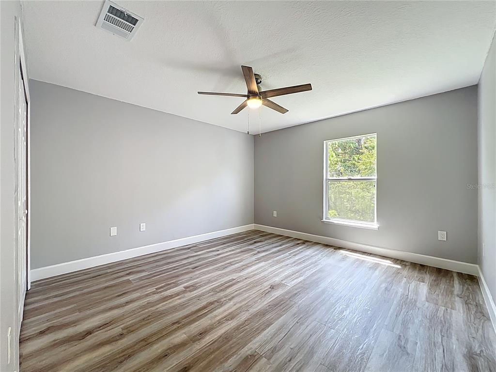11963 Bentry Street Orlando, FL 32824 - Photo 38 of 80 wooden floor in an empty room with a window