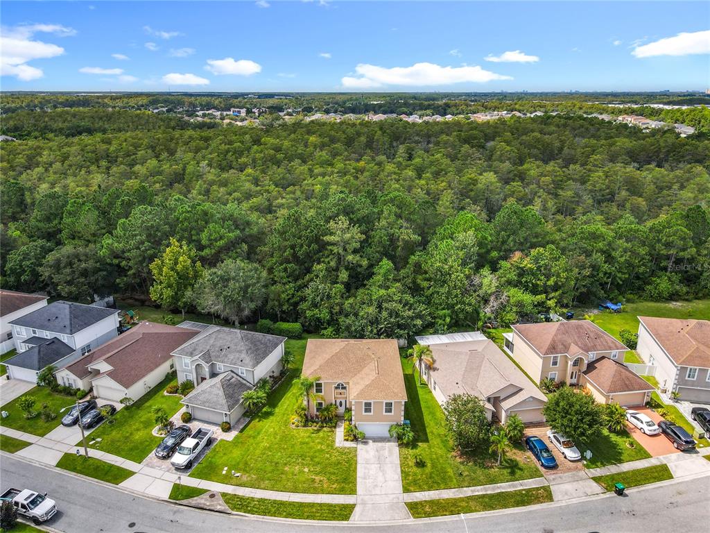 11963 Bentry Street Orlando, FL 32824 - Photo 4 of 80 an aerial view of a house with a garden and lake view