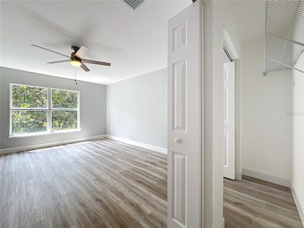 11963 Bentry Street Orlando, FL 32824 - Photo 41 of 80 wooden floor in an empty room with a window