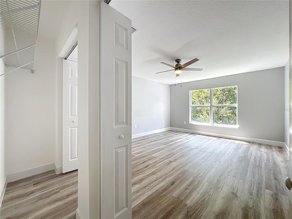 11963 Bentry Street Orlando, FL 32824 - Photo 42 of 80 a view of an empty room with a window and wooden floor