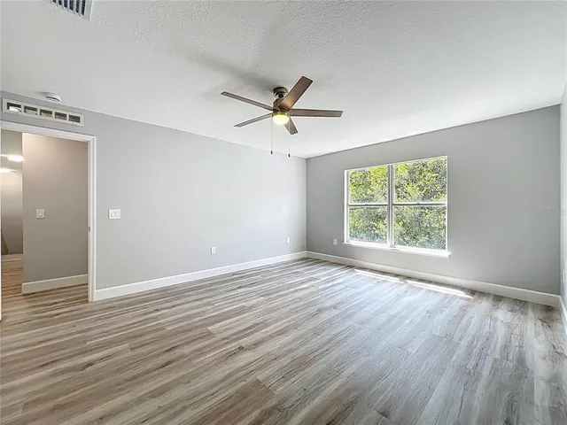 a view of a field of grass and trees