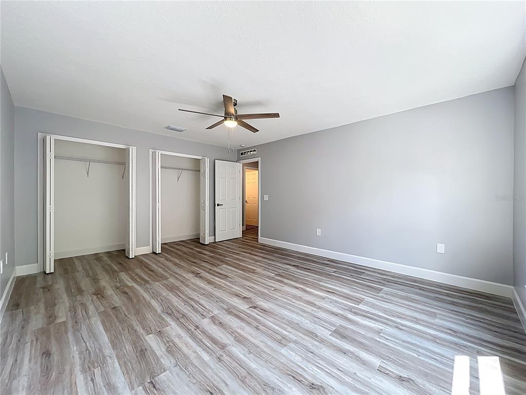 11963 Bentry Street Orlando, FL 32824 - Photo 44 of 80 a view of an empty room with wooden floor and a window
