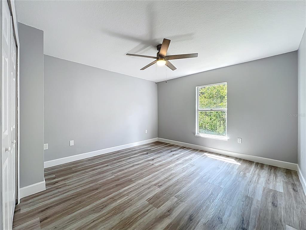 11963 Bentry Street Orlando, FL 32824 - Photo 47 of 80 a view of empty room with wooden floor and fan