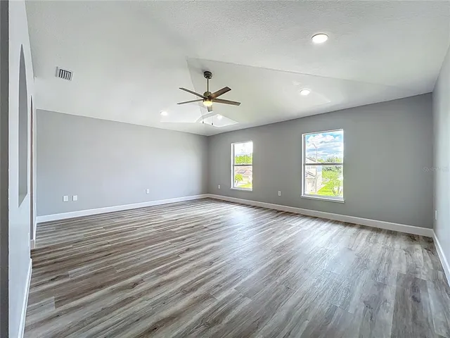 an aerial view of a house with garden space and outdoor seating
