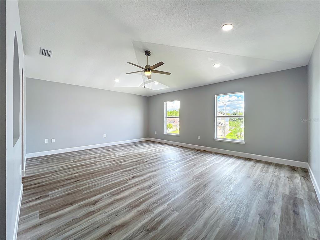 11963 Bentry Street Orlando, FL 32824 - Photo 49 of 80 an empty room with wooden floor and windows