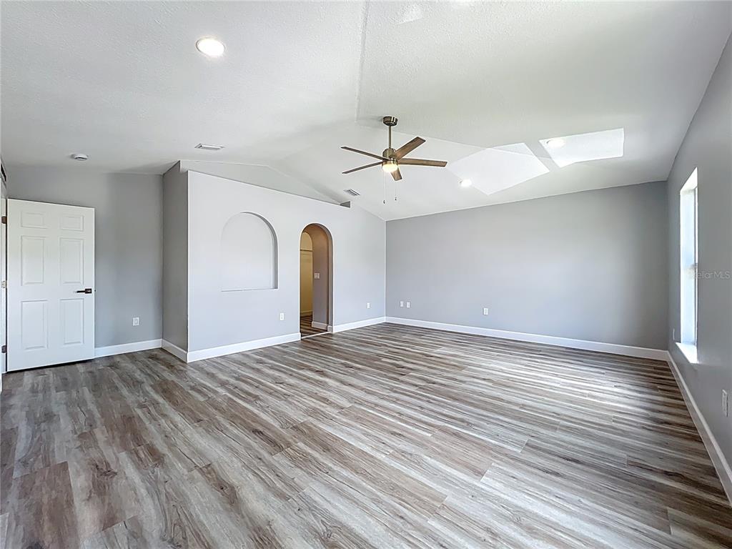 11963 Bentry Street Orlando, FL 32824 - Photo 50 of 80 a view of an empty room with a window and wooden floor