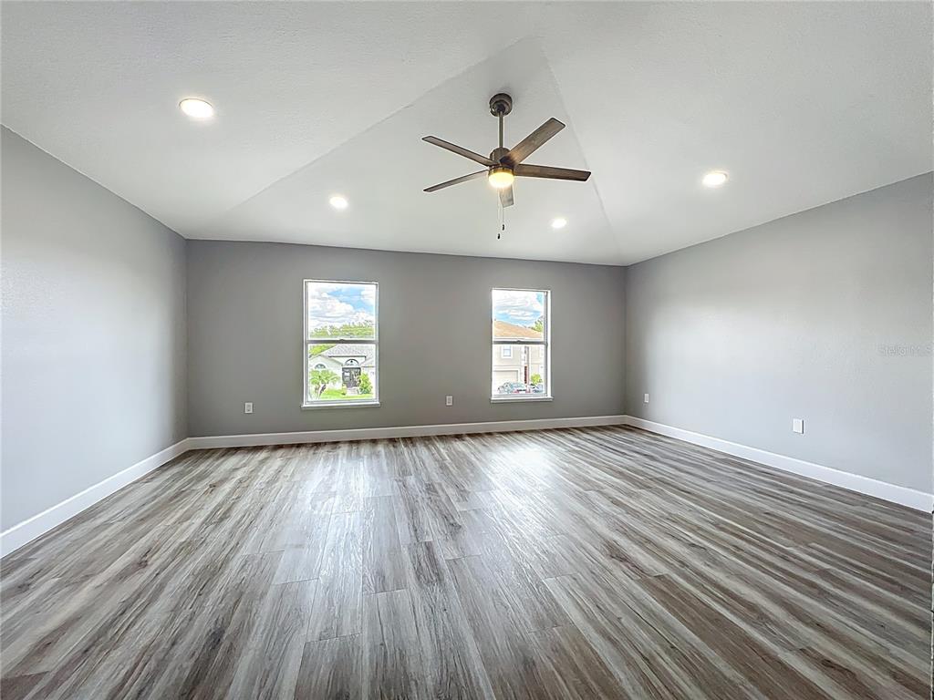 11963 Bentry Street Orlando, FL 32824 - Photo 53 of 80 a view of an empty room with a window and wooden floor