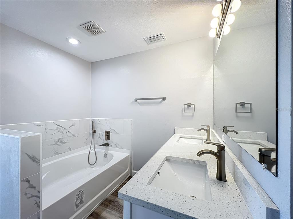 11963 Bentry Street Orlando, FL 32824 - Photo 57 of 80 a bathroom with a sink and a bathtub