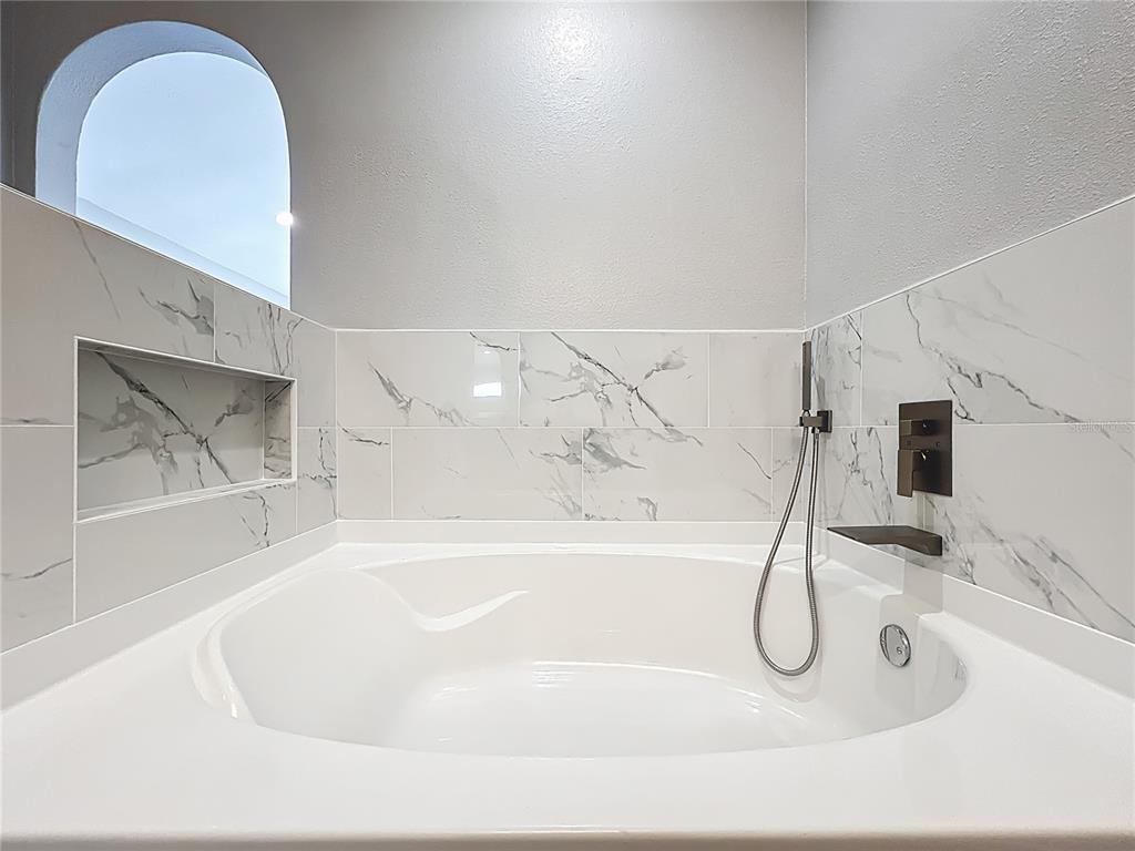 11963 Bentry Street Orlando, FL 32824 - Photo 60 of 80 a bathroom with a bathtub and a sink