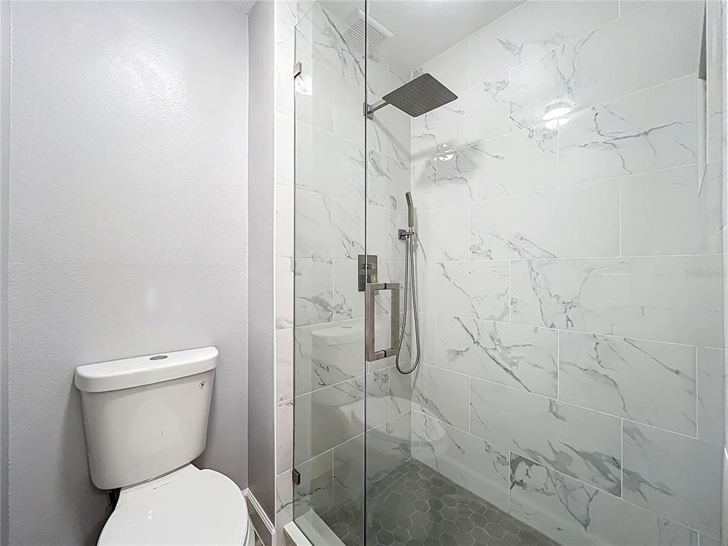 11963 Bentry Street Orlando, FL 32824 - Photo 64 of 80 a bathroom with a toilet and a shower