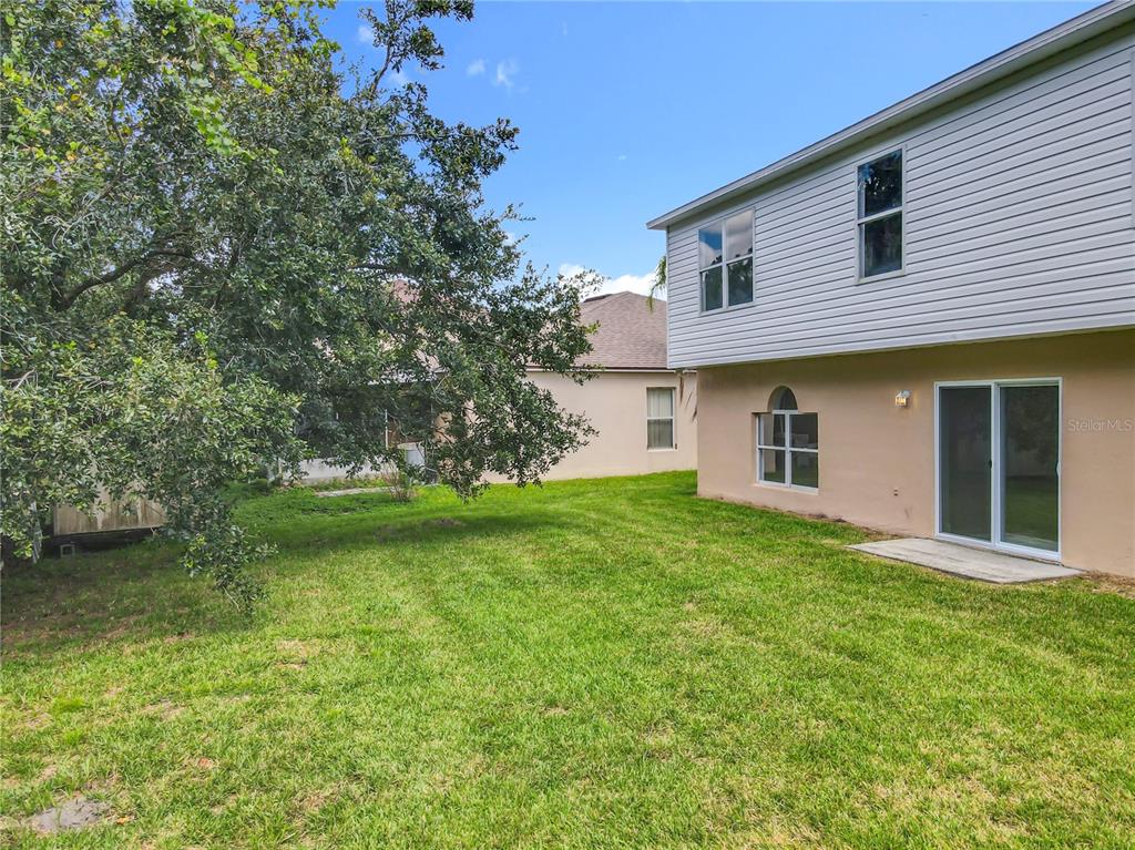 11963 Bentry Street Orlando, FL 32824 - Photo 75 of 80 a front view of a house with a garden