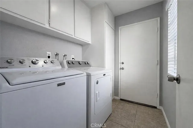 a utility room with sink dryer and washer