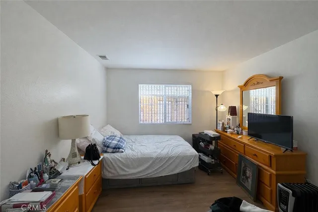 a bedroom with a bed and flat screen tv