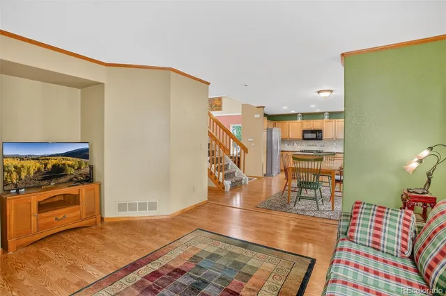 a view of a livingroom with furniture and staircase