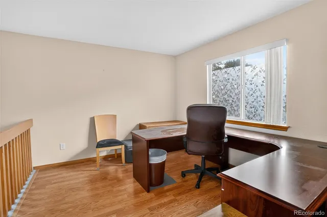 a view of a workspace with furniture and a window