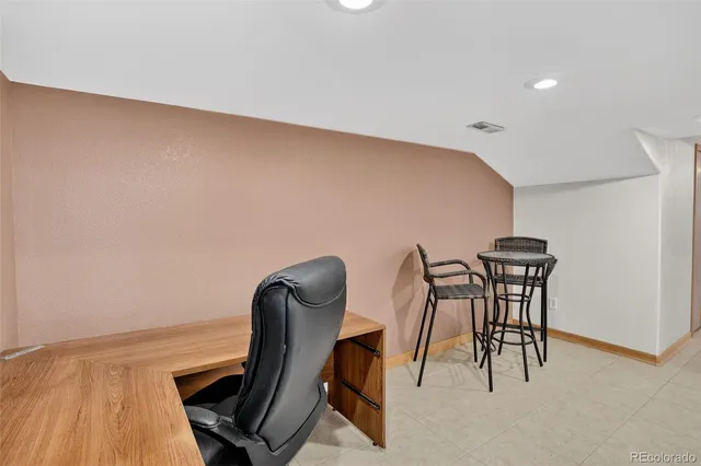 a workspace with furniture and a potted plant