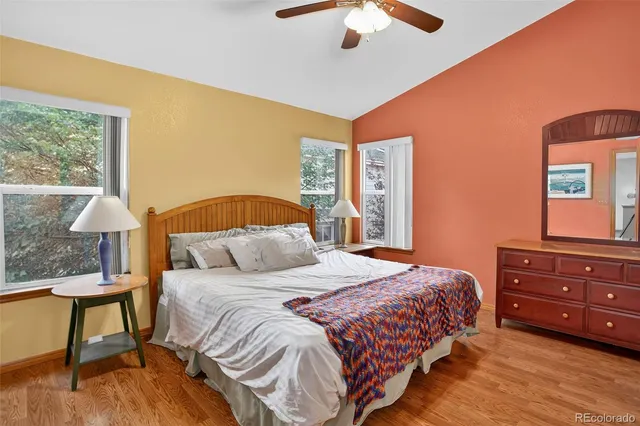 a bedroom with a bed and a dresser next to a window