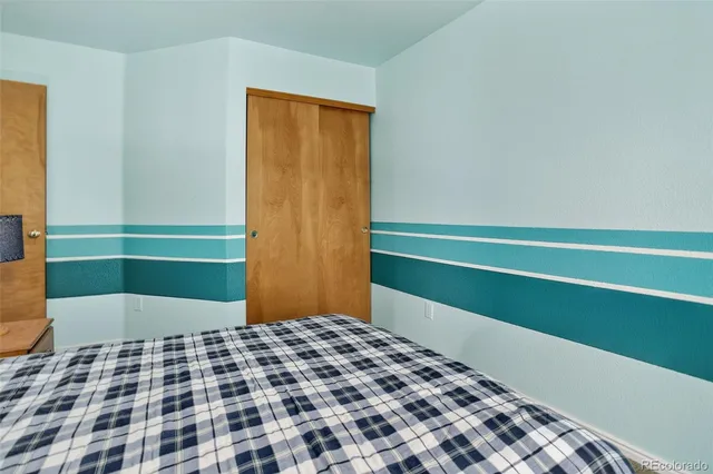 a bedroom with a bed and a cabinets