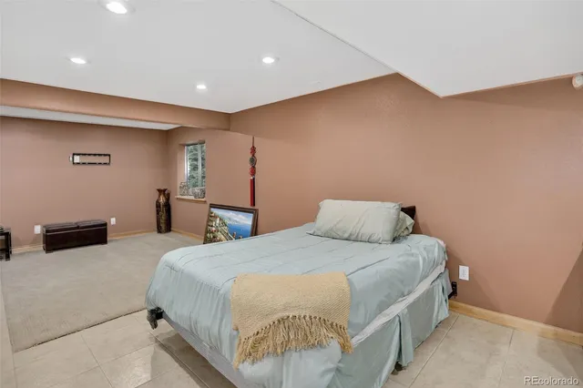 a bedroom with a bed and a couch