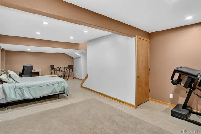 a living room with furniture gym equipment and a ceiling fan