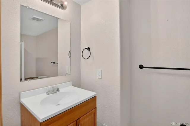 a bathroom with a sink toilet and mirror