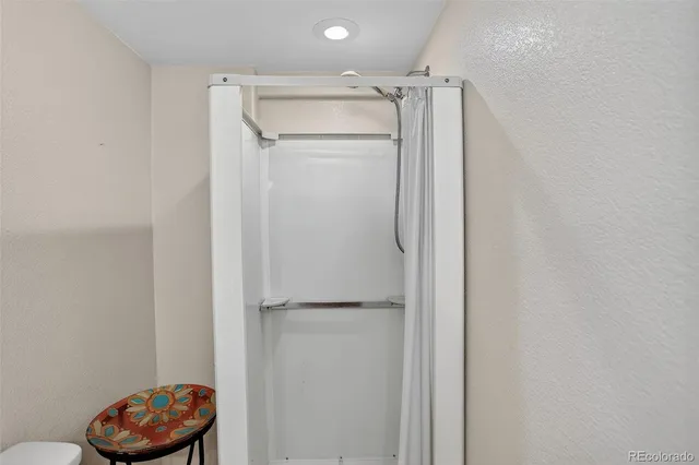 a bathroom with a granite countertop shower and a sink