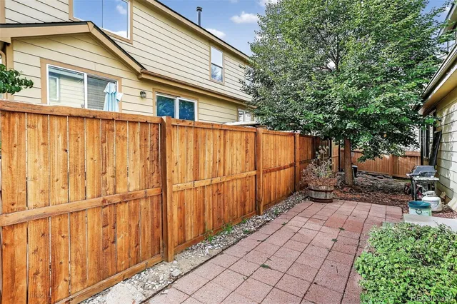 a backyard of a house with wooden fence