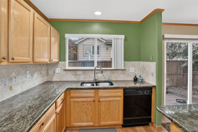 a kitchen with granite countertop a sink and cabinets